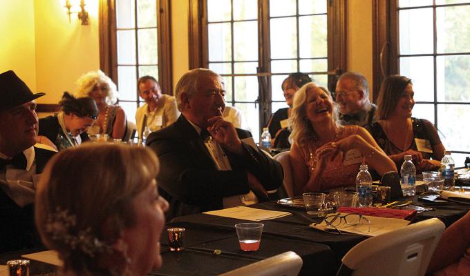 Attendees laugh and enjoy a 1920’s meal at a murder mystery dinner. Hannah Emberton | Staff Photo
