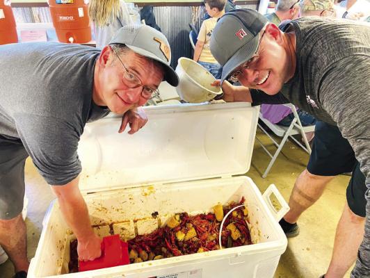 “Boil masters” Scott Tatman and Ric Voss serving up seafood during the Rotary Club’s annual seafood boil. Coffeyville Rotary Club | Courtesy Photo