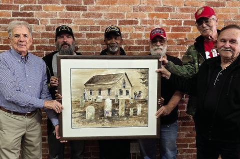 Coffeyville-raised artist Monte Toon (far left) donates his watercolor painting, “Taps,” to the Coffeyville Court of Valor Committee. This painting will be offered in a raffle drawing to help raise funds to revitalize the Veteran’s Court of Valor at Restlawn Cemetery. Hannah Emberton | Staff Photo