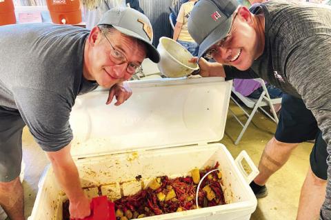 “Boil masters” Scott Tatman and Ric Voss serving up seafood during the Rotary Club’s annual seafood boil. Coffeyville Rotary Club | Courtesy Photo